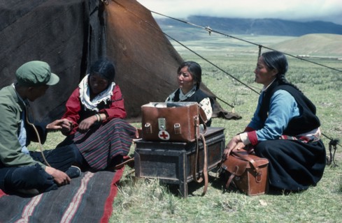 TIBET, People, Tibetan travelling doctors visiting nomad women in grassland encampment.