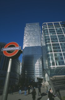 ENGLAND, London, Canary Wharf. The tower at 1 Canada Square with Underground station sign in the