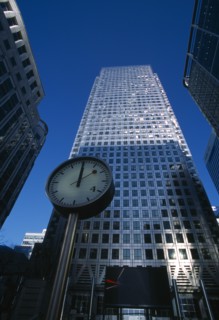 ENGLAND, London, Canary Wharf. The tower at 1 Canada Square with clock in the foreground.