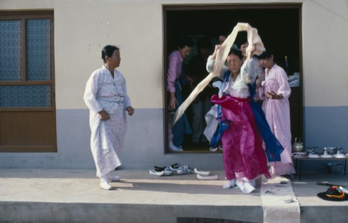 SOUTH KOREA, Religion, Shamanism, Female Shaman in a trance at a wedding waving cloth above her