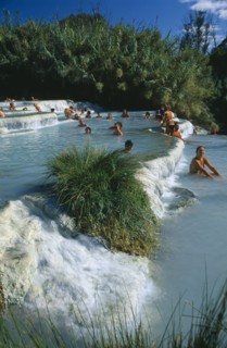 ITALY, Tuscany, Saturnia, Tourists in terraced thermal pools.