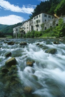 ITALY, Tuscany, Garfagnana, Bagni di Lucca.  Riverside buildings of historic spa town and bridge