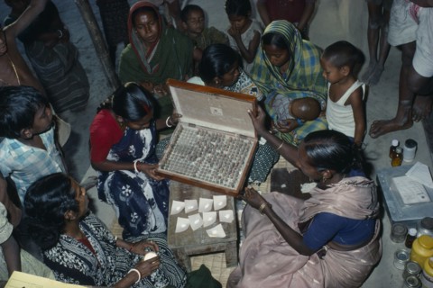 INDIA, West Bengal, "Woman doctor dispensing traditional Ayurvedic medicines at clinic.  Herbal