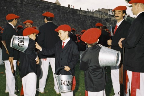 SPAIN, Hondarabia, The Basque Country, Basque marchers and fire boys relax before the festival of