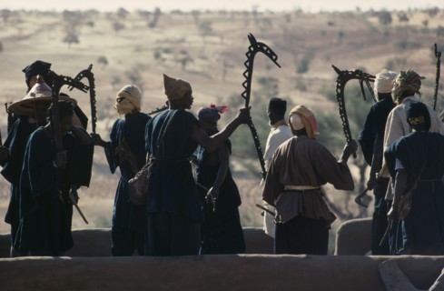 MALI, Ceremony, Dogon men carrying carved wooden staffs symbolic of ancient Dogon society