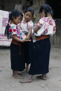 MEXICO, Chiapas, Zinacantan, Three little girls standing together in street.