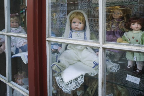 BELGIUM, West Flanders, Bruges, Assorted porcelain dolls in a shop window.