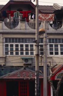 CHINA, Shanghai, Detail of Colonial architecture with washing hung out to dry on upper balcony.