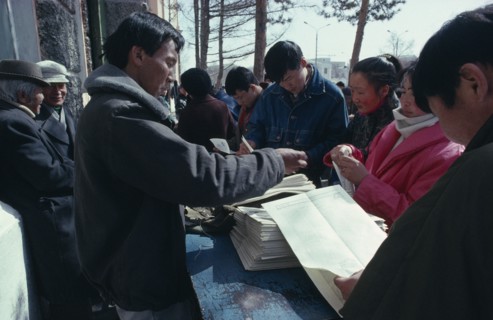 MONGOLIA, Ulaanbaatar, Newspaper vendor and customers.