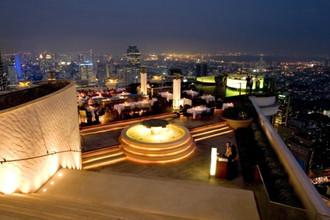 THAILAND, Bangkok, Sorocco Restaurant. View down steps towards people dining at tables lit up with