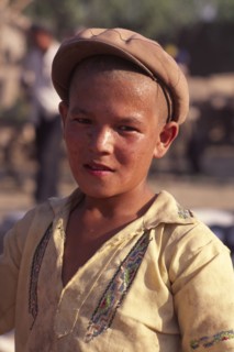 CHINA, Xinjiang Province, Kashgar, Portrait of young Tajik boy