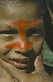 ECUADOR, People, Portrait of Auca Indian with red achote paint decorating face.