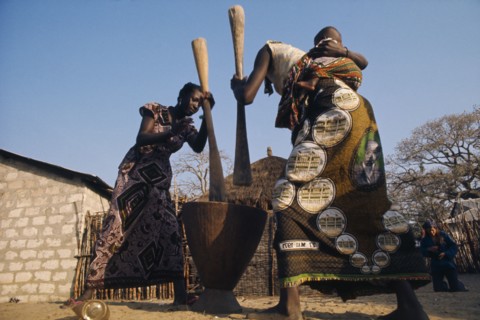 SENEGAL, Agriculture, "Women pounding maize, one carrying baby on her back."
