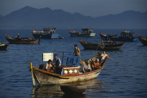 VIETNAM, Nha Trang, Fishing boats at first light off the Southern end of the beach.