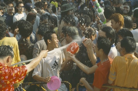 THAILAND, Bangkok, "Crowd having a water fight,  celebrating the Songkhran Festival. Thai New Year,