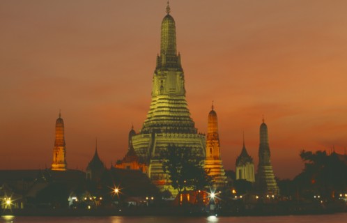 THAILAND, Bangkok, "Wat Arun, The Temple of  Dawn, on the bank of the Chao Phraya River, lit up at