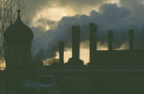 RUSSIA, Moscow, Onion dome roof of the Kremlin with smoke billowing from power station chimneys