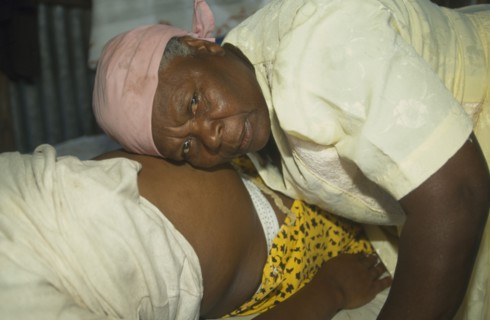 MAURITIUS, Rodrigues Island, Seventy year old traditional birth attendant listening to foetal heart