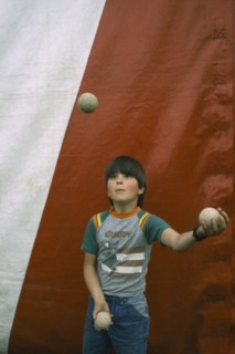 CHILDREN, Playing, Child juggling three balls.