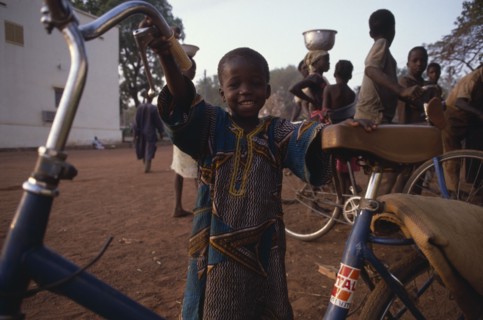 MALI, Sikasso, Little boy with bicycle.
