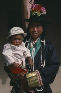 CHINA, Qinghai Province, Huzhu District, Tu minority Tibetan Buddhist mother and daughter.