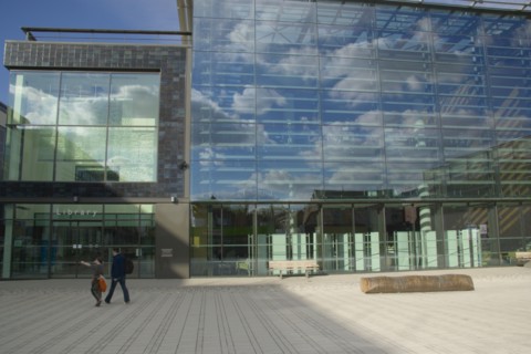 ENGLAND, East Sussex, Brighton, The Library exterior with clouds reflected in the glass and people
