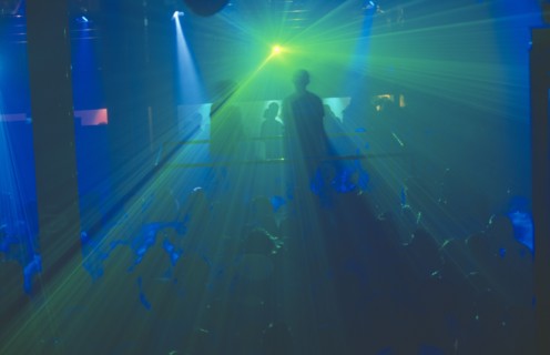 THAILAND, Bangkok, The Ministry of Sound night club. Two people on a platform above crowd of