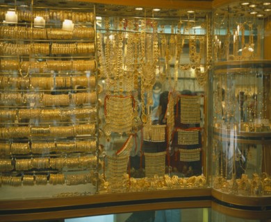 UAE, Dubai, Yellow Gold displayed in shop window. Different types of jewellery including necklaces