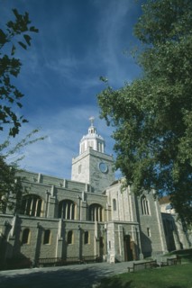 ENGLAND, Hampshire, Portsmouth, Old Portmouth. High Street. Cathedral of St Thomas framed by tree