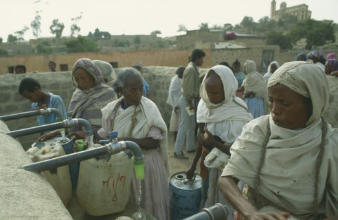 ERITREA, Seraye, Women filling containers at water point.