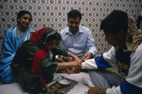 ENGLAND, Religion, Hindu, Sacred thread is fastened at the wrist of adolescent boy during Hindu