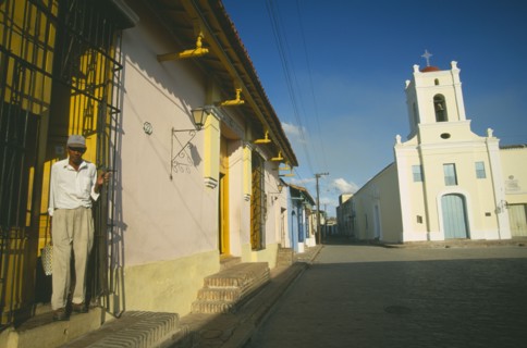 CUBA, Camaguey, Pastel coloured houses lining Playa de San Juan de Dios and Iglesia San Juan de
