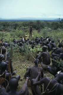 ETHIOPIA, Tribal People, Mursi tribe listening to story teller.