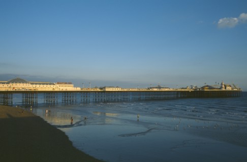 ENGLAND, East Sussex, Brighton, Brighton Pier in early evening light.