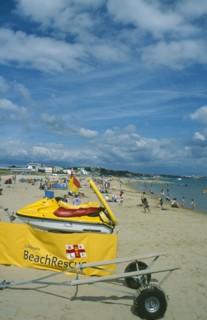 ENGLAND, Dorset, Sandbanks, Lifeboats Beach Rescue banner and Jetski on sandy beach.