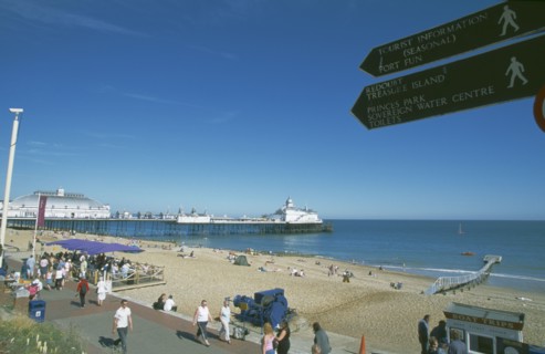 ENGLAND, East Sussex, Eastbourne, View across busy seafront towards shingle beach and pier with