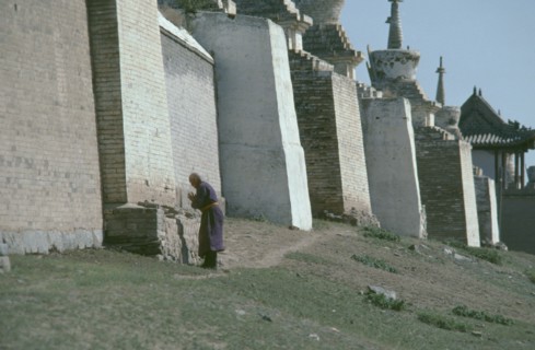 MONGOLIA, Central Gobi Province, Karakorum, Pilgrim circumnavigating city walls on site of ancient