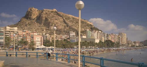 SPAIN, The Costa Blanca, Alicante. , Playa del Postiguet with Castillo de Santa Barbera rising