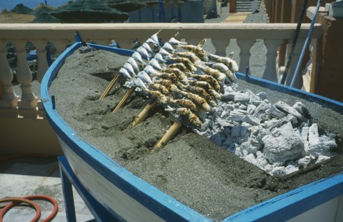 SPAIN, Andalucia, Benalmadena, Sardines on Barbecue at outside restaurant. Costa edl Sol