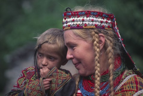 PAKISTAN, North West Frontier Province, Rumbur valley, European anthropologist with Kalash boy.