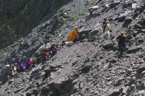 PAKISTAN, North West Frontier Province, Group of travellers negotiating a land slide on the