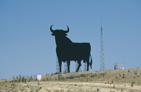SPAIN, Andalucia, Cadiz, Large silhouette statue of a bull in a field.