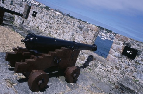 UNITED KINGDOM, Channel Islands, Guernsey, St Peter Port. Castle Cornet. Cannon next to castle wall