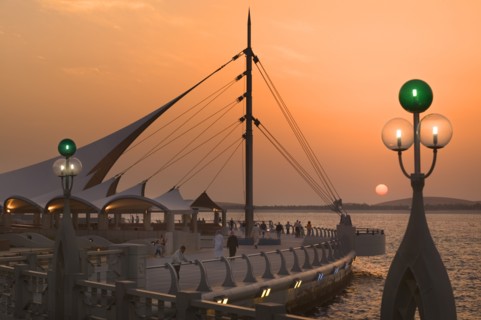 UAE, Abu Dhabi, Sun set on the Corniche promenade.