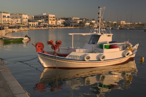 GREECE, Cyclades Islands, Naxos, HoraView of a boat docked in the port with buildings behind.