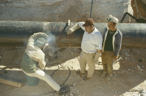 LIBYA, Work, Oil workers welding pipe.
