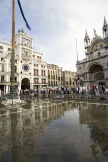 ITALY, Veneto, Venice, Aqua Alta High Water flooding in St Marks Square with tourists on elevated