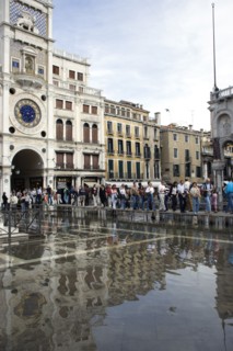 ITALY, Veneto, Venice, Aqua Alta High Water flooding in St Marks Square with tourists on elevated