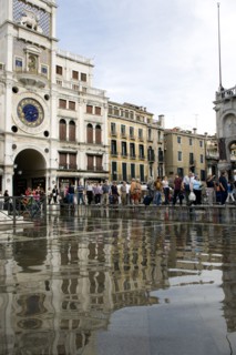 ITALY, Veneto, Venice, Aqua Alta High Water flooding in St Marks Square with tourists on elevated