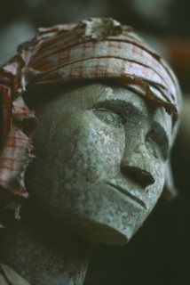 INDONESIA, Sulawesi, Face detail of Toraja wooden funeral effigy or Tau Tau placed outside the